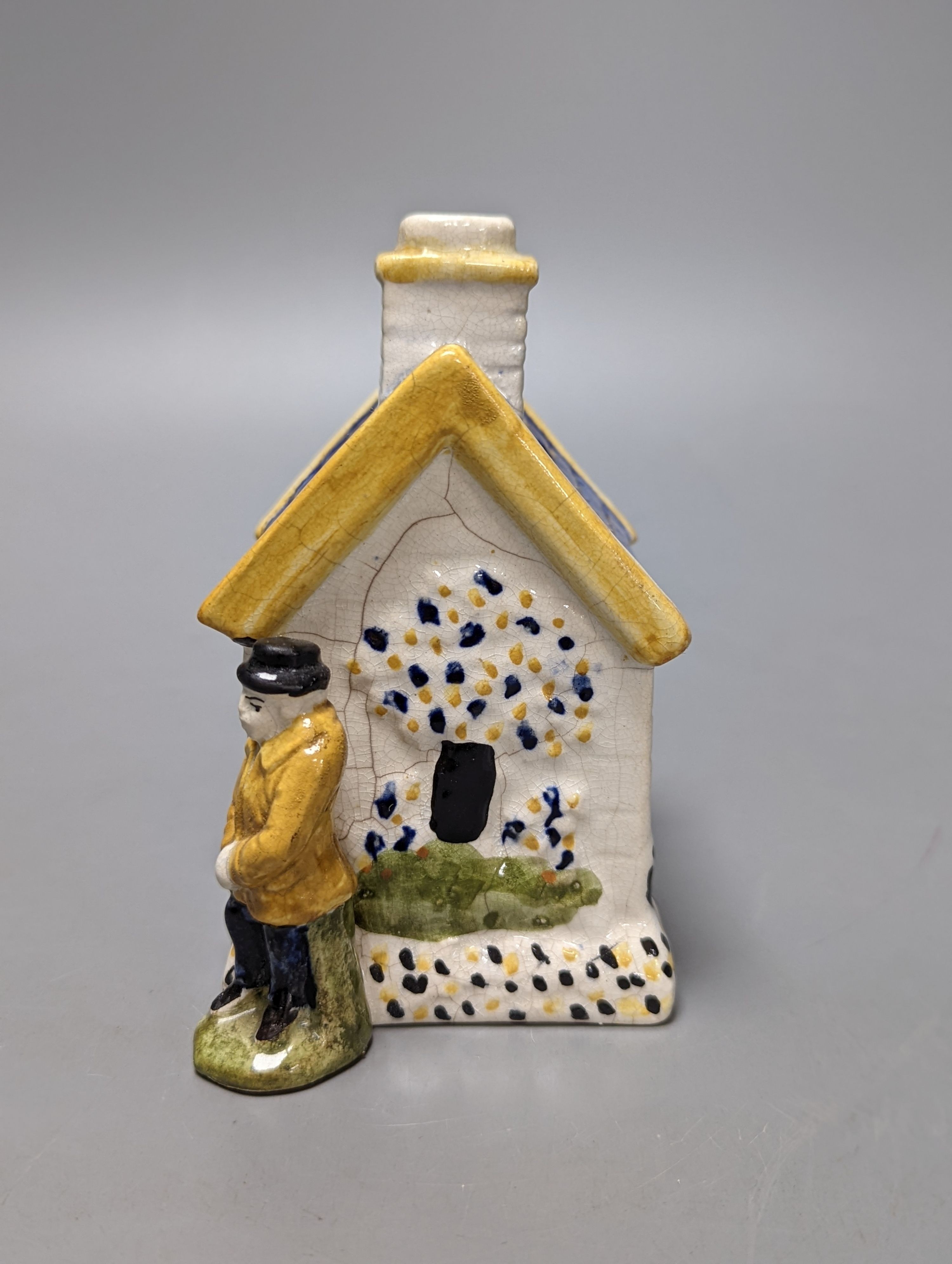 A Staffordshire Prattware money box, c.1810, and another later example (2) both 12.5cm, faults